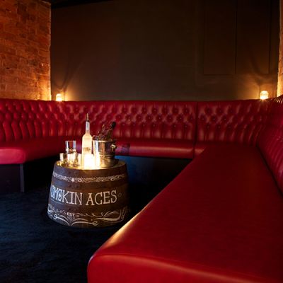 Red leather bespoke banquette seating in bar
